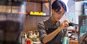 A young man working as a barista