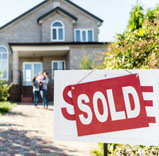 house with sold sign in front