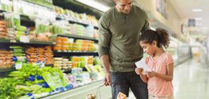 Father and daughter grocery shopping