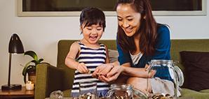 Mother and young daughter counting and separating coins