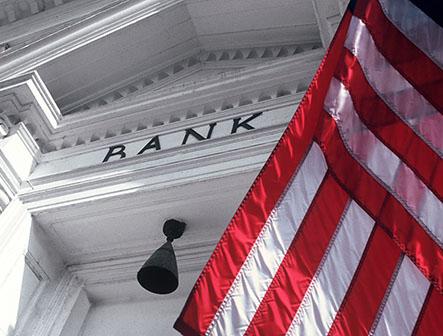 close up of bank facade with US flag across the right corner