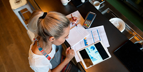 A lady organizing her finances while tending to her job