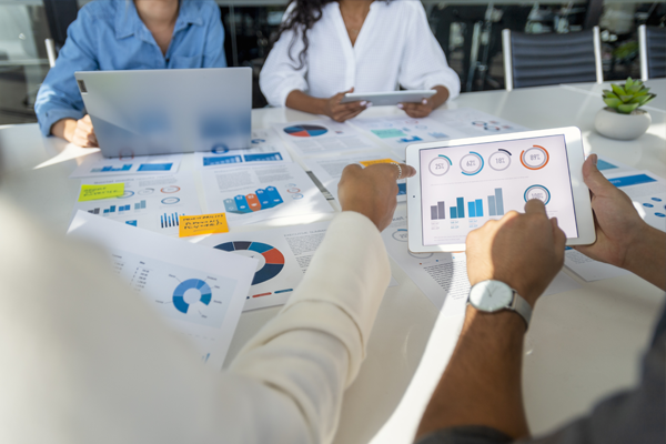 People looking at graphs around a table