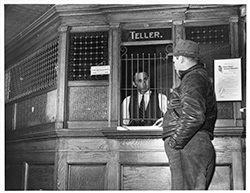 Image of Teller Window of Durham Loan and Trust Company displaying FDIC Sign and FDIC Certificate of Insurance