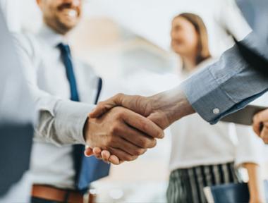 shaking hands in business setting